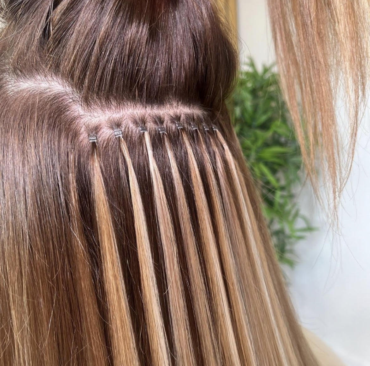 Nano tip extension beads close up showing tiny rings in hair
